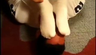 Two Young Men-One Sniffing The Other's Socks