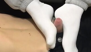 Gay teen gives socked footjob