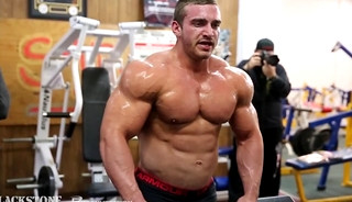 Cody Montgomery posing in black briefs