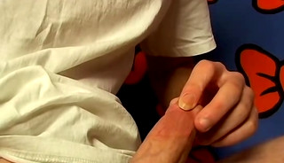 Cute guy strokes his dick before he cums in a glass of water