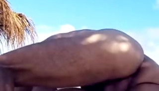 masked man having sex on the beach