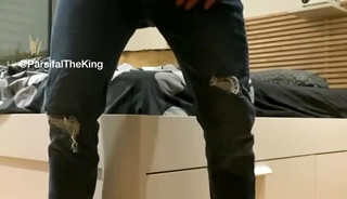 A muscular guy standing and masturbating, then licking his own cum.